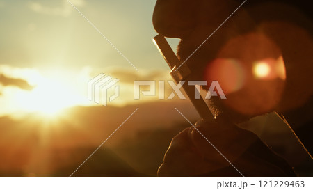 Christian man kisses crucifix illuminated by beams of divine light Christian man kisses crucifix illuminated by beams of divine light 121229463