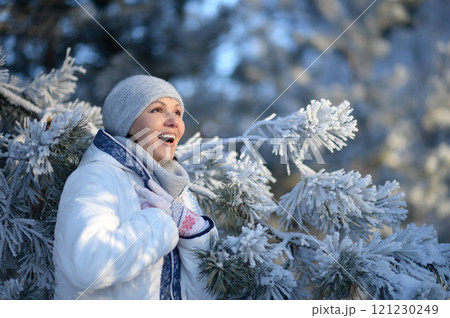 Portrait of beautiful woman posing in winter park 121230249