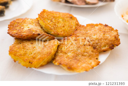 Potato pancakes with sour cream on white plate Potato pancakes with sour cream on white plate 121231393