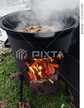 cooking pilaf in a cauldron on fire cooking pilaf in a cauldron on fire 121231486