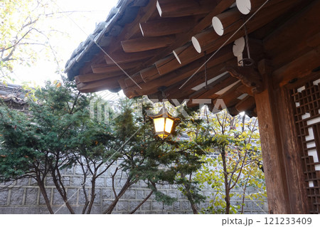 a traditional korean-style building with a sloped roof adorned with ornate decorations.	 121233409