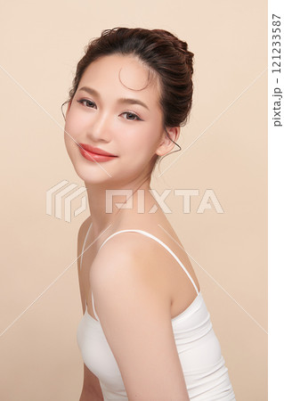 Beautiful young asian woman with clean fresh skin on beige background, Face care, Facial treatment, Cosmetology, beauty and spa, Asian women portrait. Beautiful young asian woman with clean fresh skin on beige background, Face care, Facial treatment, Cosmetology, beauty and spa, Asian women portrait. 121233587