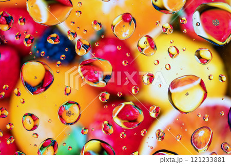 Splash of water drops on glass with colorful background. 121233881