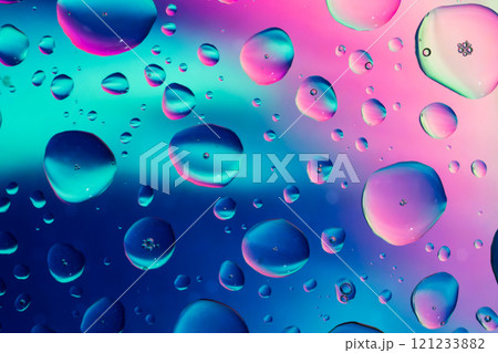 Splash of water drops on glass with colorful background. 121233882