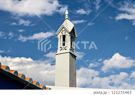Typical ornate chimney of the Algarve, Portugal, on blue background 121235463