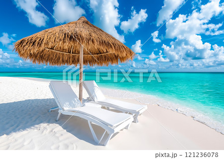 Two lounge chairs under an umbrella on a sandy beach Two lounge chairs under an umbrella on a sandy beach 121236078