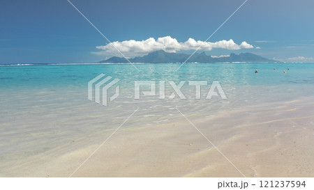 Travel to Tahiti tropical island. Turquoise crystal clear water, white sand beach, bright sunny sky, tourists people enjoy vacation. Moorea in background. Remote nature paradise, exotic summer travel 121237594