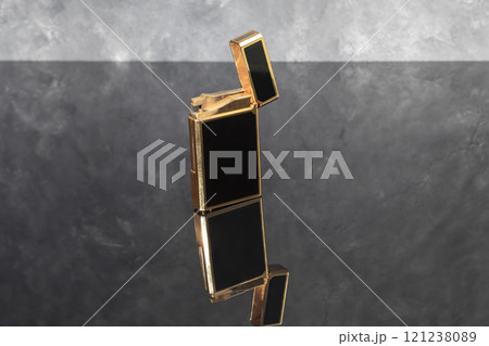 High quality lighter in a box on a dark background. Office interior. High quality lighter in a box on a dark background. Office interior. 121238089