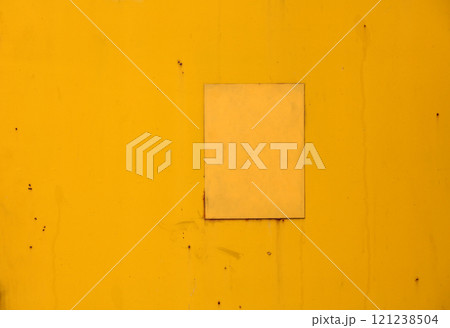 Yellow painted metal surface showing signs of ageing and wear Yellow painted metal surface showing signs of ageing and wear 121238504
