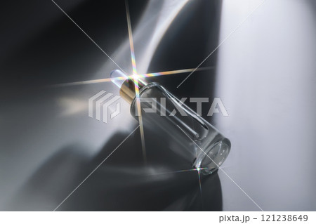 Bottle of face serum with a pipette with a beautiful highlight. 121238649