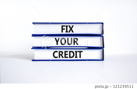 Fix your credit symbol. Concept words Fix your credit on books on a beautiful white table white background. Business, finacial and fix your credit concept. Copy space. 121239511