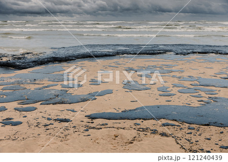 Oil in coastline after a tanker wreck. Fuel oil polluted beach Oil in coastline after a tanker wreck. Fuel oil polluted beach 121240439