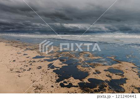 The sea and the beach are polluted with fuel oil. Beach oil spill impact, pollution, waste disposal. Ecology catastrophe. The sea and the beach are polluted with fuel oil. Beach oil spill impact, pollution, waste disposal. Ecology catastrophe. 121240441