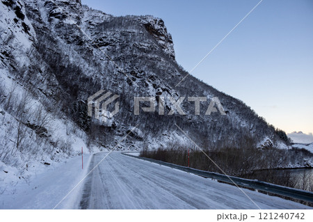 Seaside road under a big rock, Gratangen, Norway Seaside road under a big rock, Gratangen, Norway 121240742