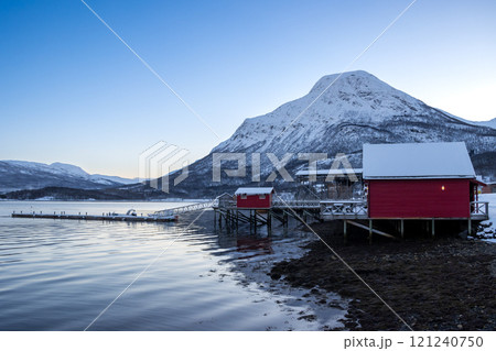 Red cabins at the coast and a mountain, Norway 121240750