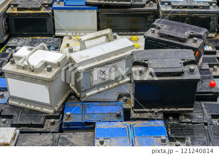Stack of many used car batteries for recycling in a hazardous waste facility 121240814