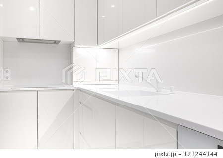Modern snow white kitchen interior with acrylic countertop 121244144
