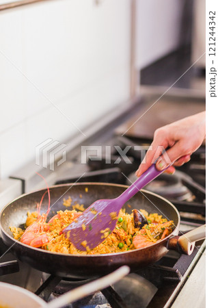 Chef cooking traditional ecuadorian seafood rice dish in madrid restaurant kitchen 121244342