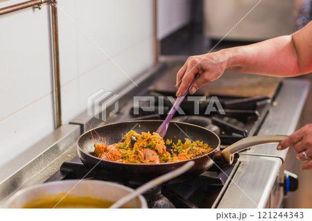 Chef preparing traditional ecuadorian seafood dish in madrid restaurant kitchen 121244343