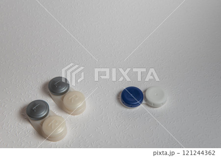 Contact lenses on white background, top view Contact lenses on white background, top view 121244362
