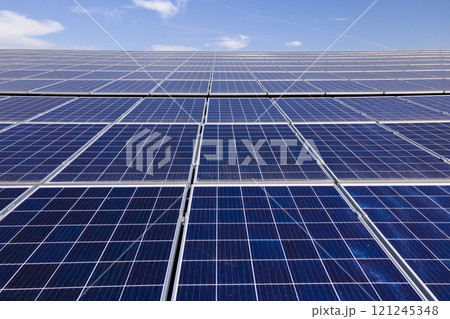 Photovoltaic panels for producing clean ecological electric energy. Commercial building with solar roof. Renewable electricity with zero emission concept Photovoltaic panels for producing clean ecological electric energy. Commercial building with solar roof. Renewable electricity with zero emission concept 121245348