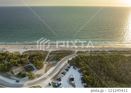 Parking lot at Florida Blind Pass beach on Manasota Key, USA. Vehicle parking area with cars parked on ocean beach parking lot. Summer vacation on beachfront 121245411