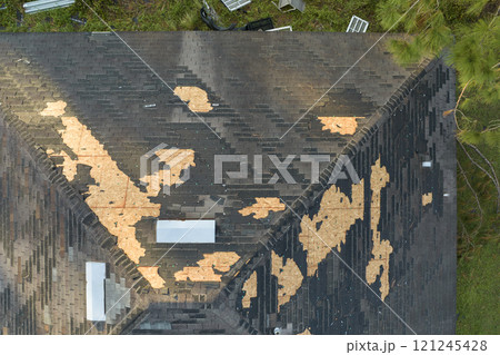 Natural disaster and its consequences. Hurricane Ian destroyed house roof in Florida residential area Natural disaster and its consequences. Hurricane Ian destroyed house roof in Florida residential area 121245428