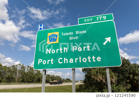 Interstate freeway exit sign in Florida, USA. I-75 highway interchange with direction to North Port and Port Charlotte 121245590