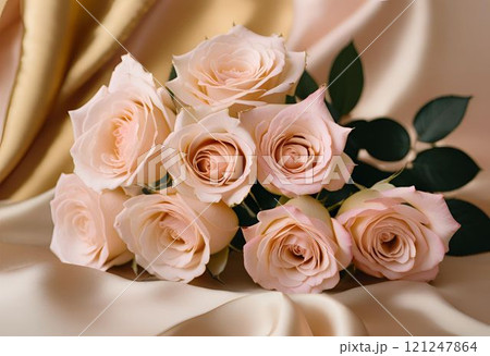 ゴールドのシルクの布の上に置かれたパステルピンクやベージュピンクのバラの花束 ゴールドのシルクの布の上に置かれたパステルピンクやベージュピンクのバラの花束 121247864