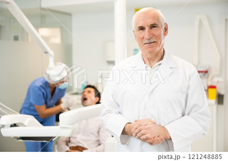 Elderly man doctor in dental office 121248885