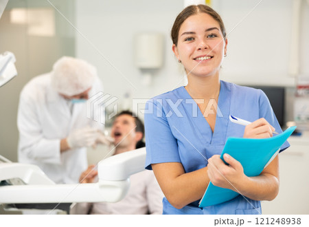 Young woman nurse taking notes in dental office Young woman nurse taking notes in dental office 121248938