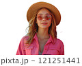A woman with a hat and sunglasses is holding a cell phone in her hand 121251441