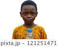 A young boy is happily holding a water bottle and smiling during an event 121251471