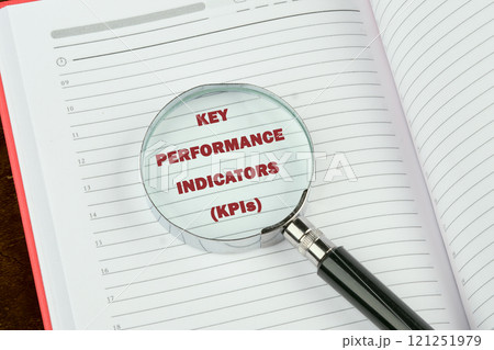 Data analytics automated with AI technology. KEY PERFORMANCE INDICATORS (KPIs) on a blank page of a business notebook through a magnifying glass Data analytics automated with AI technology. KEY PERFORMANCE INDICATORS (KPIs) on a blank page of a business notebook through a magnifying glass 121251979
