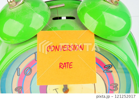 Business concept. The conceptual text of the CONVERSION RATE close-up, on a yellow sticker on the background of an alarm clock 121252017