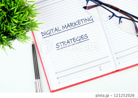 Online sales concept of digital marketing, Business concept. The text of DIGITAL MARKETING STRATEGIES close-up, on a blank sheet of notepad 121252026