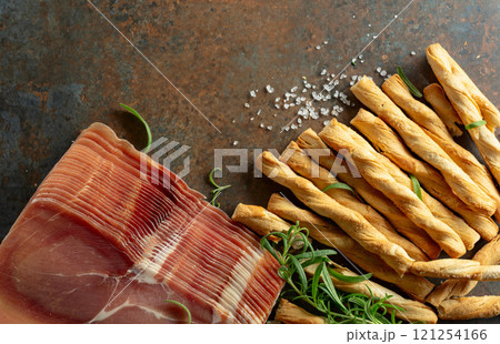 Prosciutto with bread sticks and rosemary. 121254166