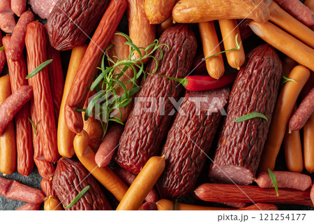Various dry-cured and smoked sausages with red peppers and rosemary. Various dry-cured and smoked sausages with red peppers and rosemary. 121254177