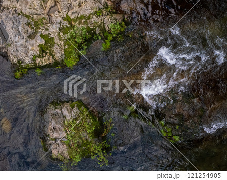 flow water over brown rock. 121254905