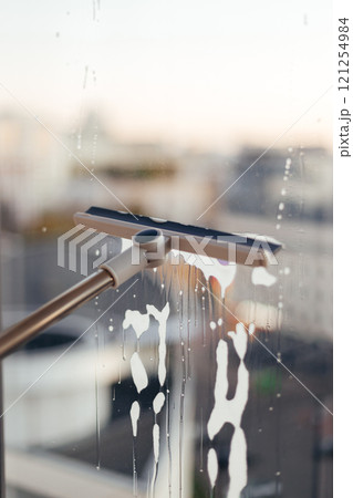Window cleaning brush for windows. Washing windows with a window brush 121254984