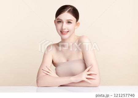 Beautiful young asian woman with clean fresh skin on beige background, Face care, Facial treatment, Cosmetology, beauty and spa, Asian women portrait. 121257740