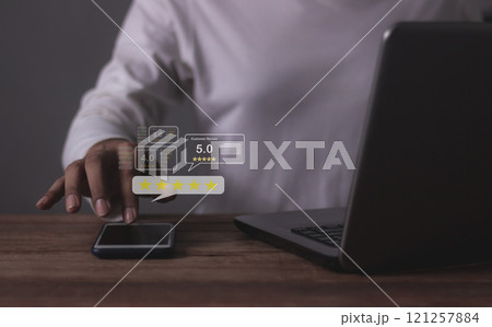Customer Review, Young Man hand using Smart Phone and laptop with five star to review  121257884