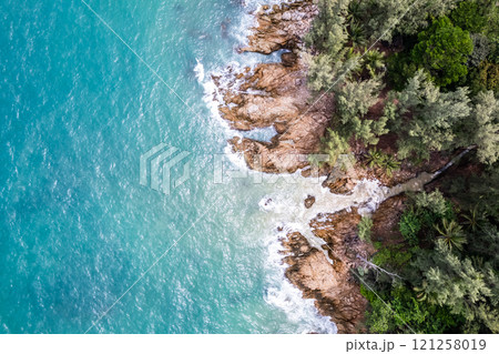 Bird eye view seashore with waves crashing on rock cliff, Beautiful waves sea surface in sunny day summer background, Amazing seascape top view seacoast landscape view 121258019