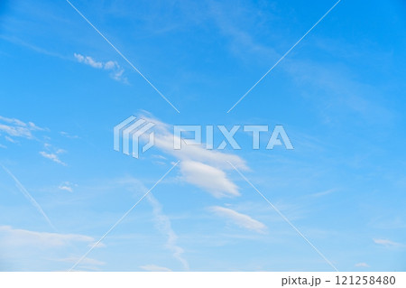 Wispy White Clouds Floating Gracefully in a Clear Blue Sky Over the Beautiful Netherlands Landscape 121258480