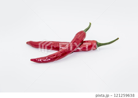 Two Chili peppers isolated on white background. Hot ripen chili peppers without GMO. Organic mexican spices Two Chili peppers isolated on white background. Hot ripen chili peppers without GMO. Organic mexican spices 121259638