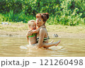 mom and child swim in the river 121260498