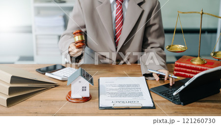 justice and law concept. Male judge in a courtroom the gavel, working with smart phone and laptop and digital tablet 121260730