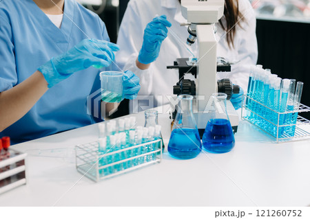 Modern Medical Research Laboratory Portrait of Team Scientists Working, Using Digital Tablet, Analyzing Samples, Talking. for Medicine, Biotechnology Development 121260752