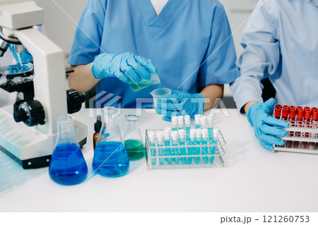Modern Medical Research Laboratory Portrait of Team Scientists Working, Using Digital Tablet, Analyzing Samples, Talking. for Medicine, Biotechnology Development Modern Medical Research Laboratory Portrait of Team Scientists Working, Using Digital Tablet, Analyzing Samples, Talking. for Medicine, Biotechnology Development 121260753