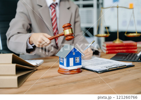 Real Estate Lawyer And House Foreclosure Law. House model, hammer judge gavel on table with white background. Foreclosure, bankruptcy concept 121260766